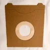 A brown vacuum cleaner bag with a circular opening in the center. Produktbild-Vorschau