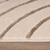 A close-up view of a beige rug with abstract brown lines. Produktbild-Vorschau
