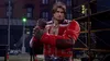 A male character in a red jacket stands in a city street at night. Náhľad obrázku produktu