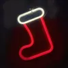 A neon Christmas stocking decoration against a dark background. Voir les images du produit