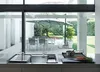 A modern kitchen sink area with a view of an outdoor patio and dining area. Náhľad obrázku produktu