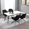 A dining set with a white table and four black chairs on a rug. Produktbild-Vorschau