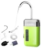 A green and silver automatic water pump with various accessories laid out beside it, with a stream of water flowing from its spout. Náhľad obrázku produktu