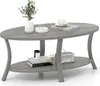 A gray oval coffee table with two shelves, decorated with a plant, books, a cup of coffee, and a vintage radio. Produktbild-Vorschau