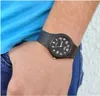 A close-up shot of a person's wrist wearing a black watch. Produktbild-Vorschau