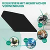 A black wedge cushion is shown with various use cases illustrated around it, including a wheelchair, an office chair, a gaming chair, and someone reading on the floor. Produktbild-Vorschau