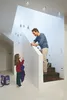 A father and daughter are interacting on a staircase in a modern home. Voir les images du produit