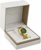 A gold Versace watch with a green face is displayed inside its white and gold presentation box. Náhled obrázku produktu