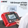 A red and black digital multimeter with a screen displaying readings, presented on a desk with a person's hand interacting with the device. Promotional text and graphics are overlaid. Podgląd zdjęcia produktu