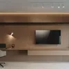 A modern living room or office space with a wall-mounted television and a desk. Produktbild-Vorschau