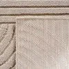 A close-up view of a beige bouclé rug with a textured pattern. Podgląd zdjęcia produktu