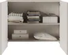 An open cabinet with shelves displaying folded clothes, boxes, and a pillow. Anteprima dell’immagine prodotto