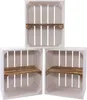 Three white wooden crates with wooden shelves are arranged in a staggered formation against a white background. Produktbild-Vorschau