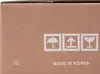 A close-up of a cardboard box with shipping symbols and text. Produktbild-Vorschau