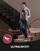 A woman is vacuuming a carpeted staircase with a cordless vacuum cleaner. Produktbild-Vorschau