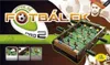 The image shows the packaging of a foosball table game for two players, with a man in the background and a close-up of the game itself. Náhľad obrázku produktu