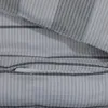 A close-up view of a striped fabric, likely bedding, showing a seam and a pocket. Produktbild-Vorschau