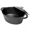 A black cast iron oval pot with its lid slightly ajar, set against a white background. Anteprima dell’immagine prodotto