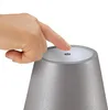 A finger pressing a power button on a gray lamp. Anteprima dell’immagine prodotto