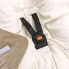 A close-up view of a baby car seat harness and a blanket. Produktbild-Vorschau