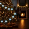 A family is gathered around a decorated Christmas tree with presents underneath, in a cozy room with a fireplace. Náhled obrázku produktu