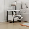A modern white nightstand with a black metal frame next to a bed. Produktbild-Vorschau