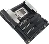 A high-angle shot of a black motherboard with silver heatsinks and a silver CPU socket. Produktbild-Vorschau