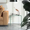 A modern living room scene with a couch and a glass side table. Produktbild-Vorschau