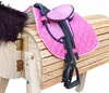 A close-up view of a pink saddle on a wooden toy horse. Produktbild-Vorschau