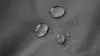 Close-up of water droplets on a textured gray fabric surface. Produktbild-Vorschau