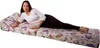A woman lying on a floral patterned folding mattress. Anteprima dell’immagine prodotto