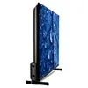 A side view of a black flat-screen television with a close-up image of blue leaves with water droplets displayed on the screen. Produktbild-Vorschau