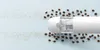 A white portable vacuum cleaner is shown on a light blue background, surrounded by coffee beans and small white particles, suggesting its cleaning capabilities. Produktbild-Vorschau