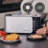 A person's hands are interacting with a toaster on a kitchen counter, with waffles and tomatoes nearby. Voir les images du produit