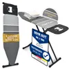 An ironing board with folded clothes on it, and marketing labels. Produktbild-Vorschau