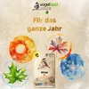 A marketing image for bird food, featuring a bag of birdseed surrounded by seasonal imagery and text. Produktbild-Vorschau
