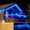 Blue icicle lights decorating the exterior of a house at night. Náhľad obrázku produktu
