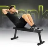 A man is performing sit-ups on a black flat bench in a gym-like setting with glowing text in the background. Náhľad obrázku produktu