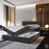 A modern bedroom with a box spring bed that has its storage compartment open. Produktbild-Vorschau