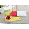 Four cutting boards of different colors are arranged on a countertop, with a red bell pepper on the yellow board. Produktbild-Vorschau