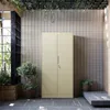 A beige metal cabinet with two doors stands in an outdoor or patio setting with plants and a woven wall. Anteprima dell’immagine prodotto