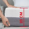 A close-up shot of a mattress with hands touching it, indicating its thickness. Produktbild-Vorschau