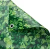 A close-up view of a green leaf-patterned privacy screen, folded at the corner. Produktbild-Vorschau