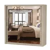 A mirrored wardrobe with a light wood finish, reflecting a bedroom interior. Voir les images du produit
