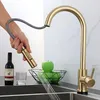 A hand is holding a pull-out kitchen faucet sprayer, with water spraying out into a sink. A bottle of wine, a glass, and a bowl of green apples are on the counter next to the faucet. Náhled obrázku produktu