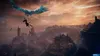 A person is being carried by a large, blue, mythical bird over a misty, mountainous landscape at sunset. Produktbild-Vorschau