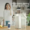 A woman drinks water while a water filter pitcher and filter cartridge are displayed. Anteprima dell’immagine prodotto