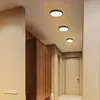 A hallway with three ceiling lights, a wooden cabinet, and a door. Produktbild-Vorschau