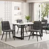 A dining table set with chairs in a well-lit room.
