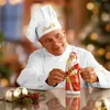 A chef in a white uniform and hat is holding a chocolate Santa Claus figure. Náhled obrázku produktu